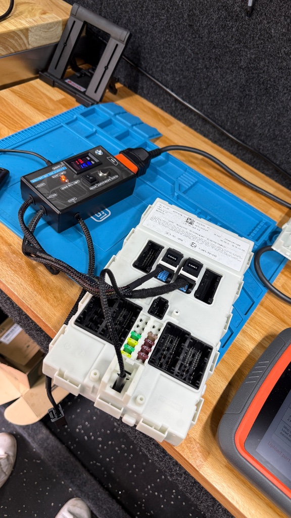BMW M140i FEM module removed and connected to diagnostic interface on the bench in Abingdon