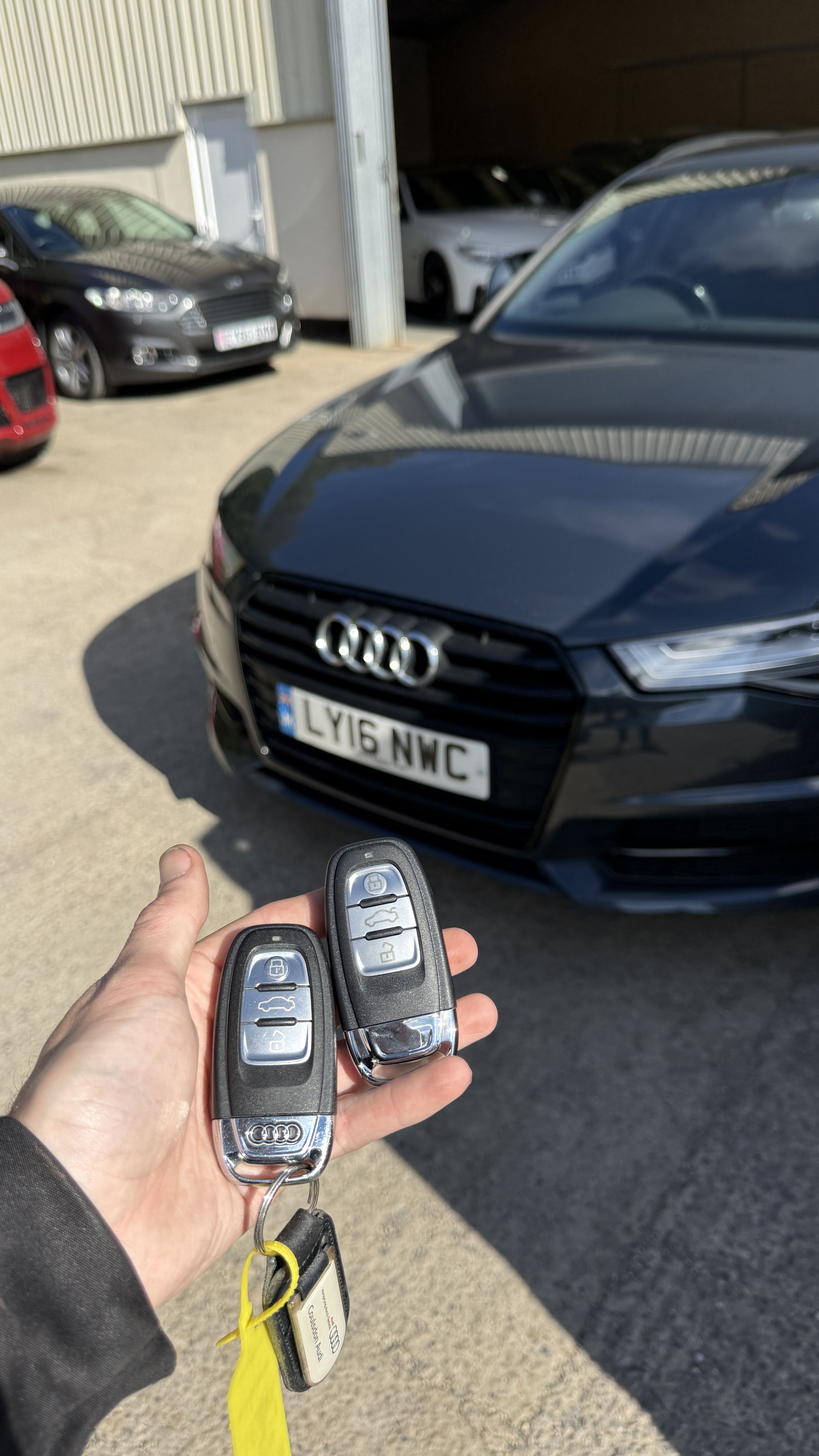 Two Audi flip keys supplied and programmed on-site by KeyLogik mobile auto locksmith