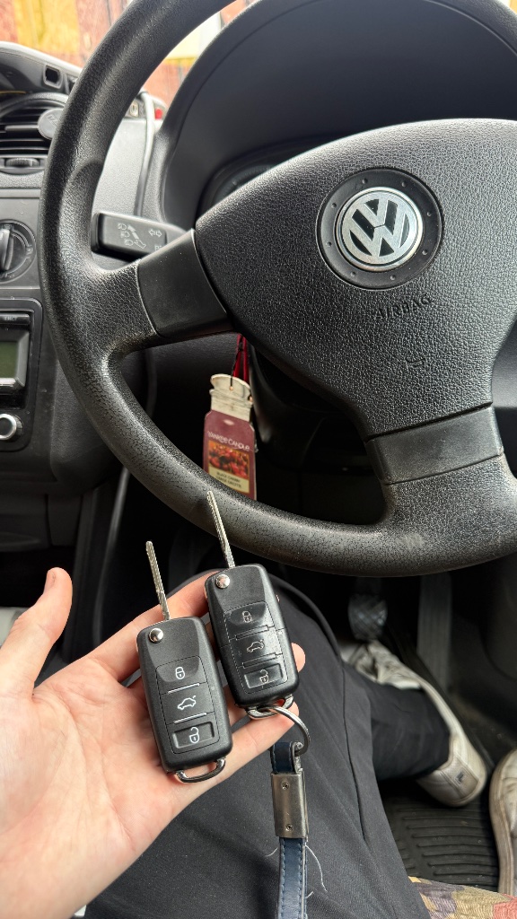 Two VW Caddy flip keys held inside the vehicle during spare key programming in St Clements, Oxford