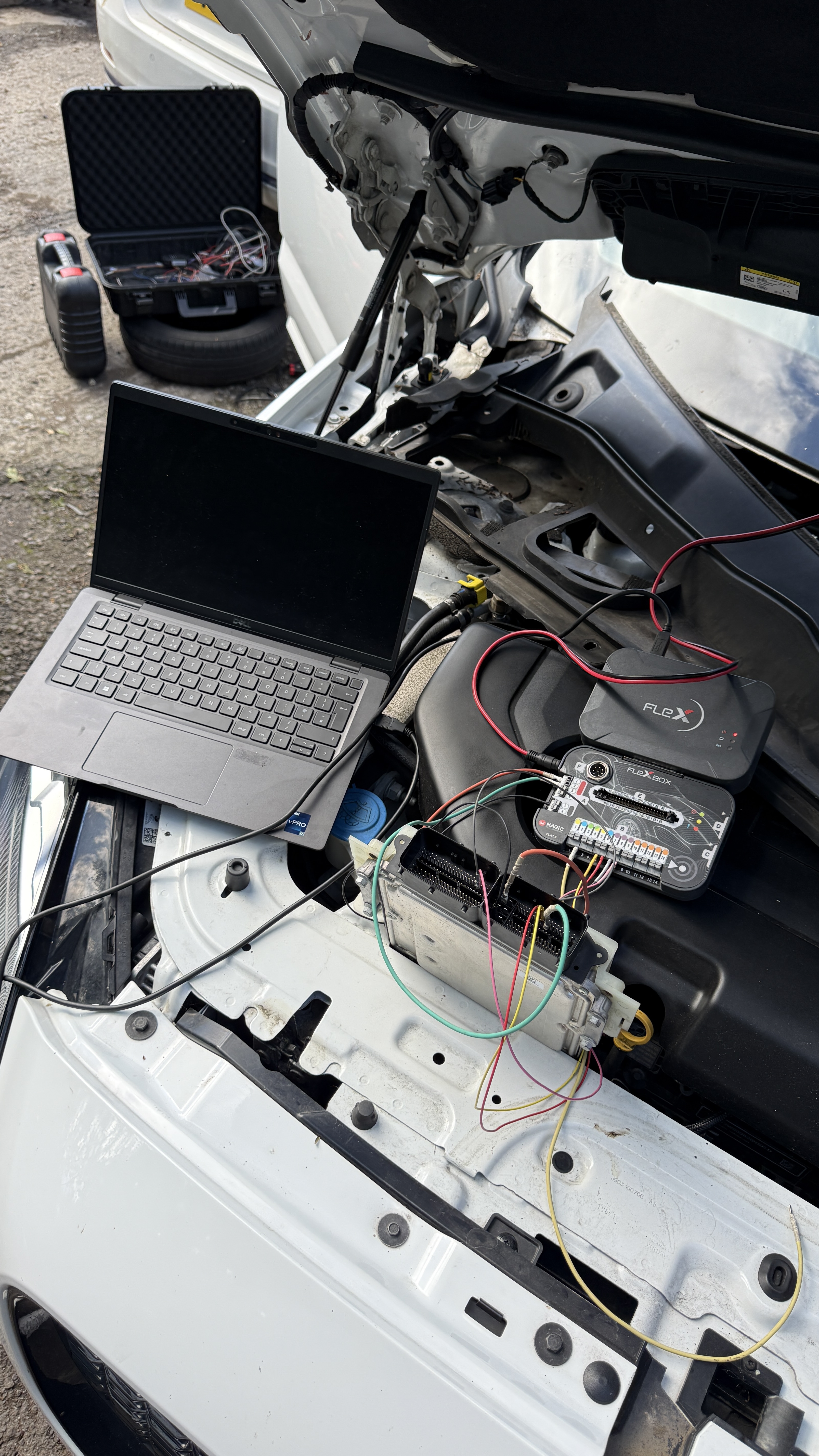 Jaguar F-Pace engine bay with ECU removed and connected to FlexBox and Dell laptop for bench remapping, carried out by KeyLogik in Stokenchurch, Buckinghamshire