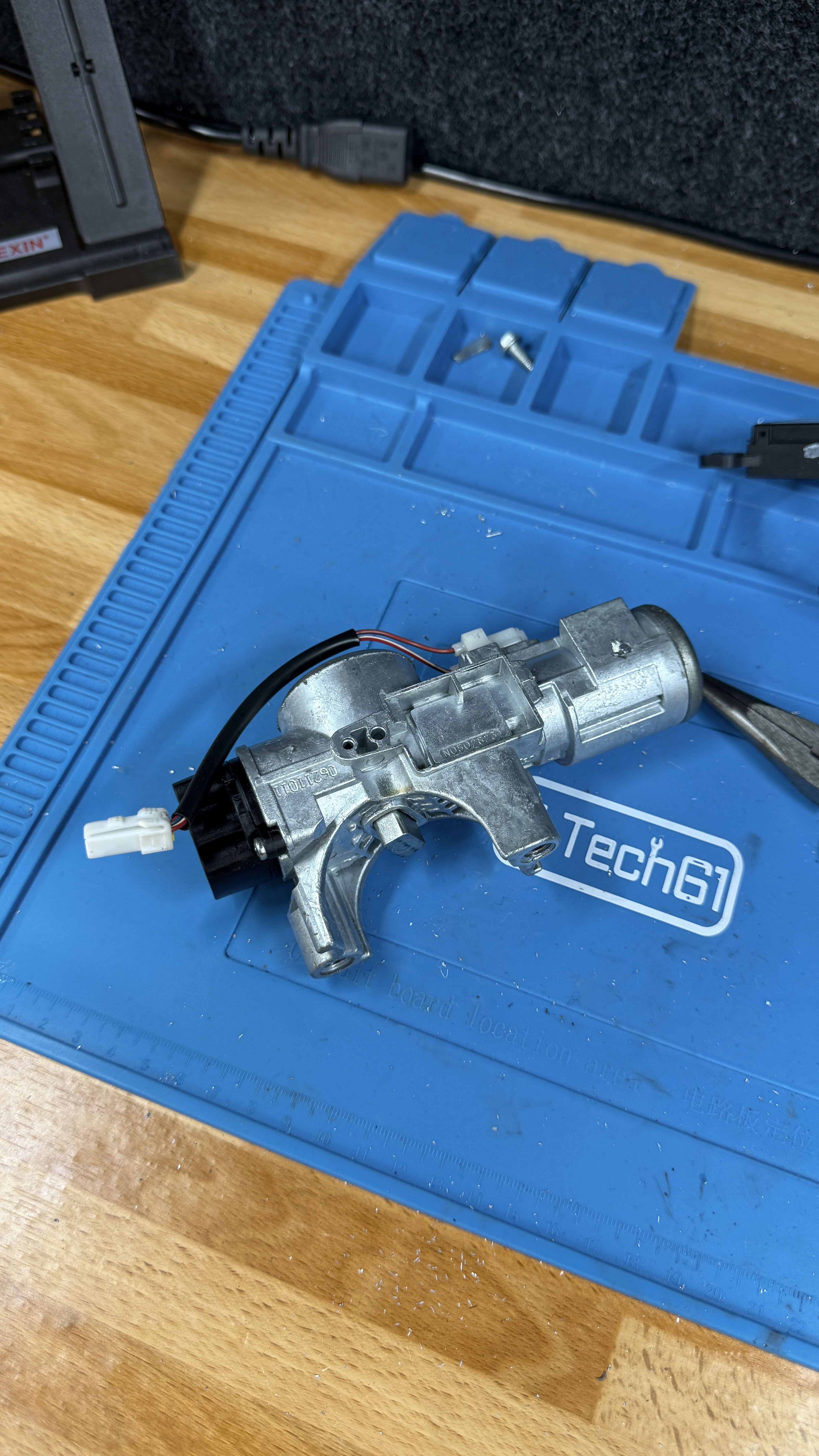 Ignition barrel assembly removed and resting on a blue workshop mat during a genuine KeyLogik mobile auto locksmith repair in Oxfordshire