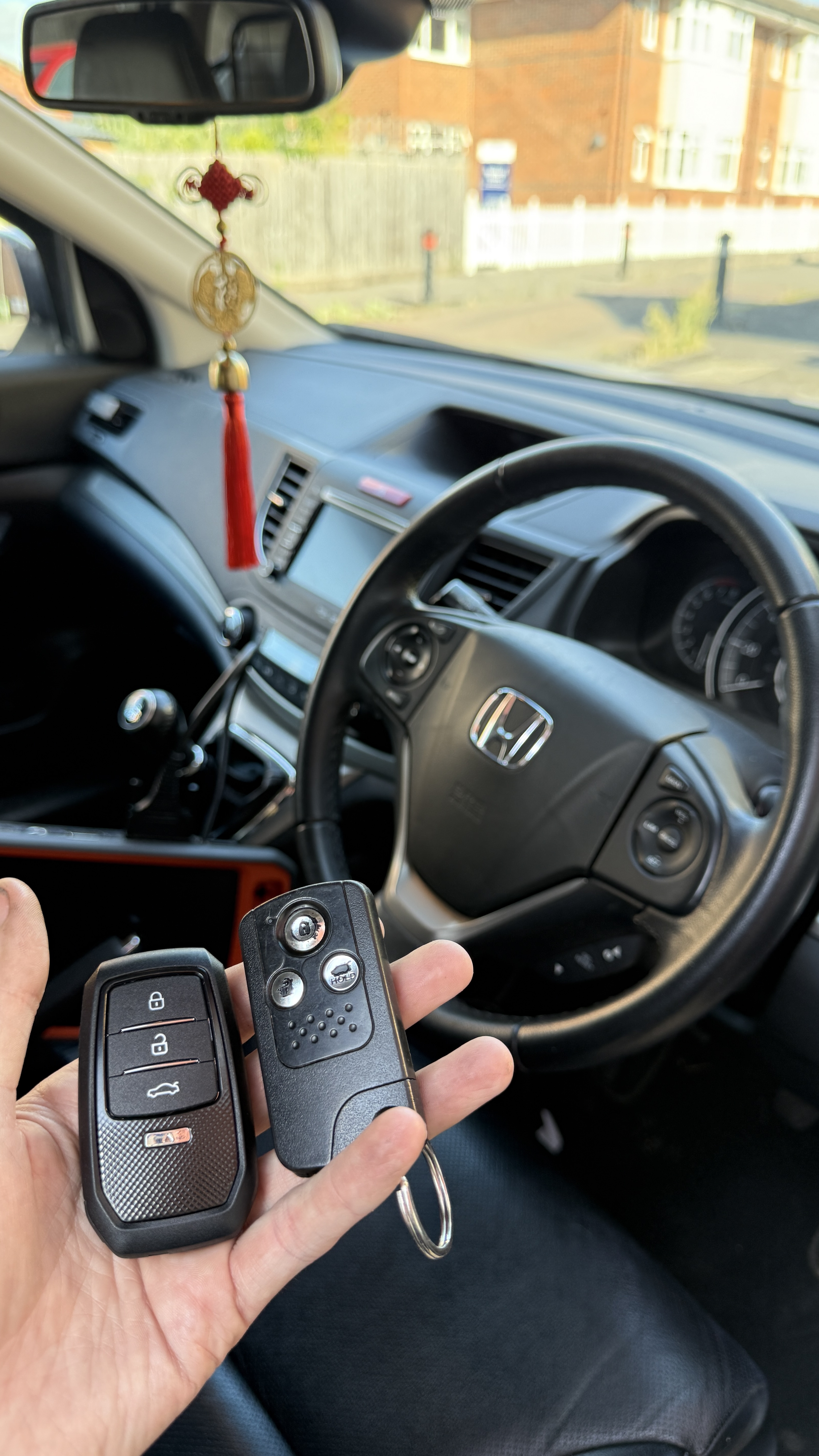 Honda CR-V interior showing the original and newly supplied spare key after programming by KeyLogik in Wallingford