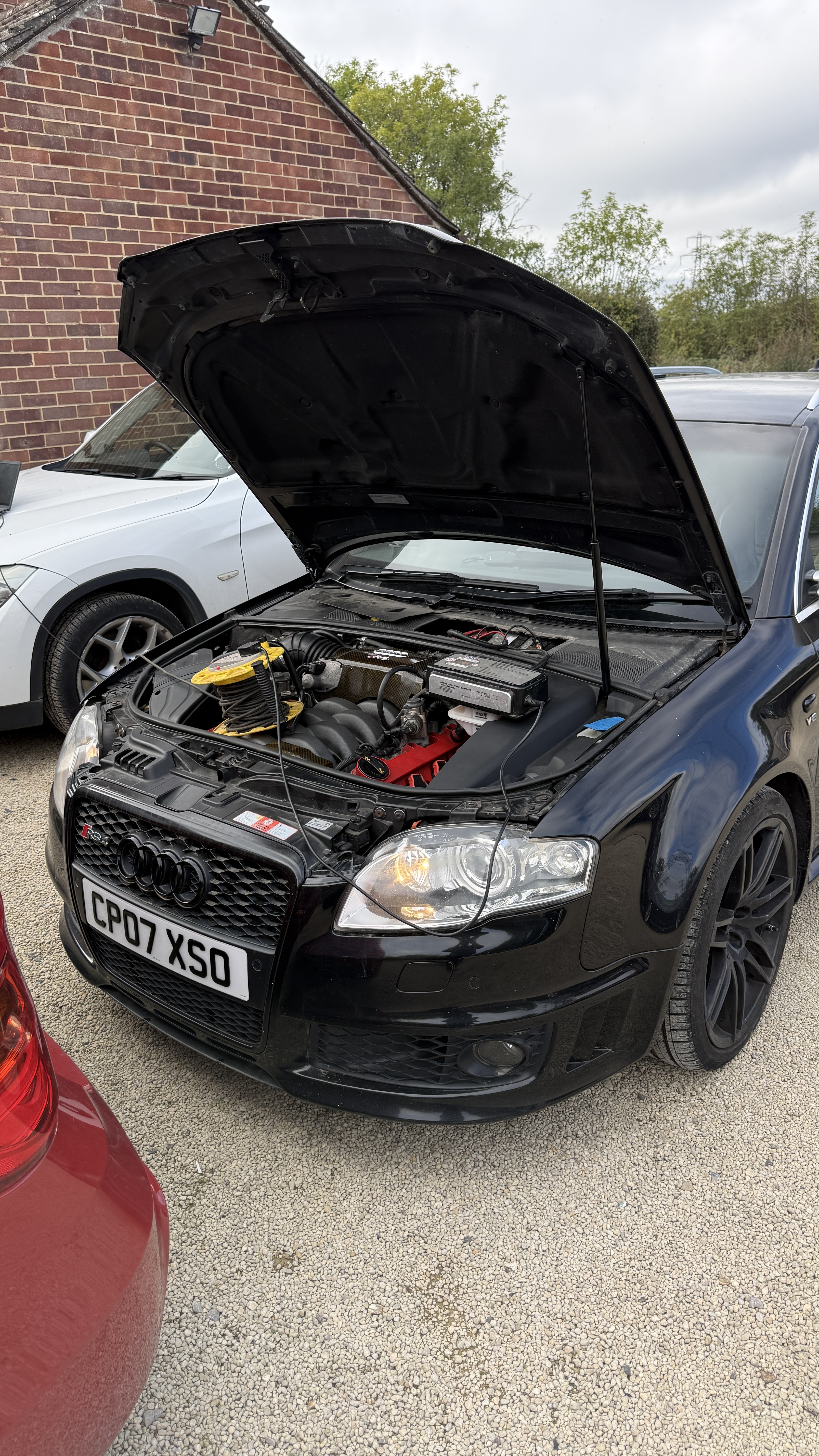 Black Audi RS4 with bonnet open during ECU remapping and intake manifold flap delete work by KeyLogik in Swindon