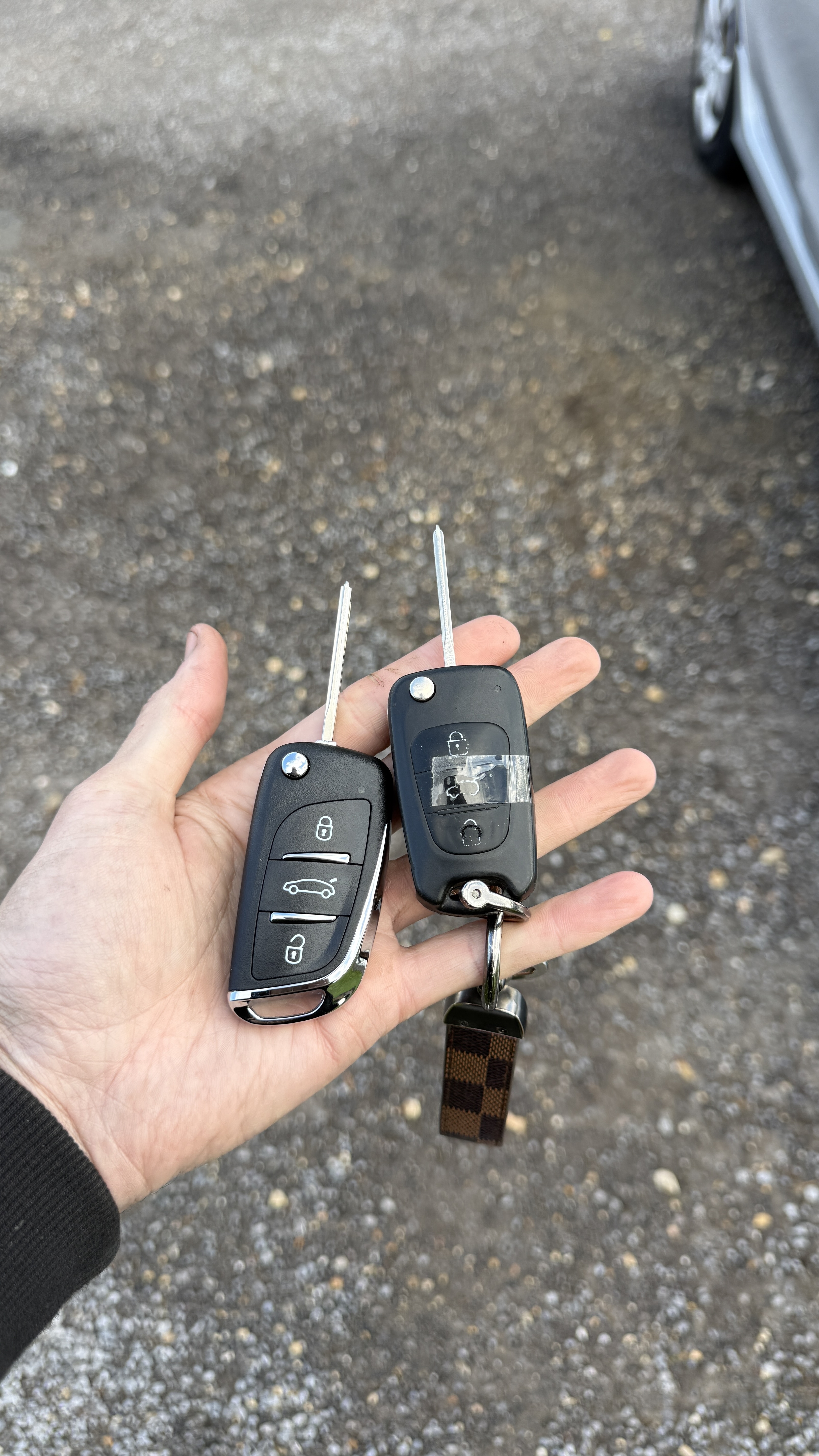 New chrome-edged spare remote key alongside the taped original Hyundai i30 key with intermittently working buttons in Guildford