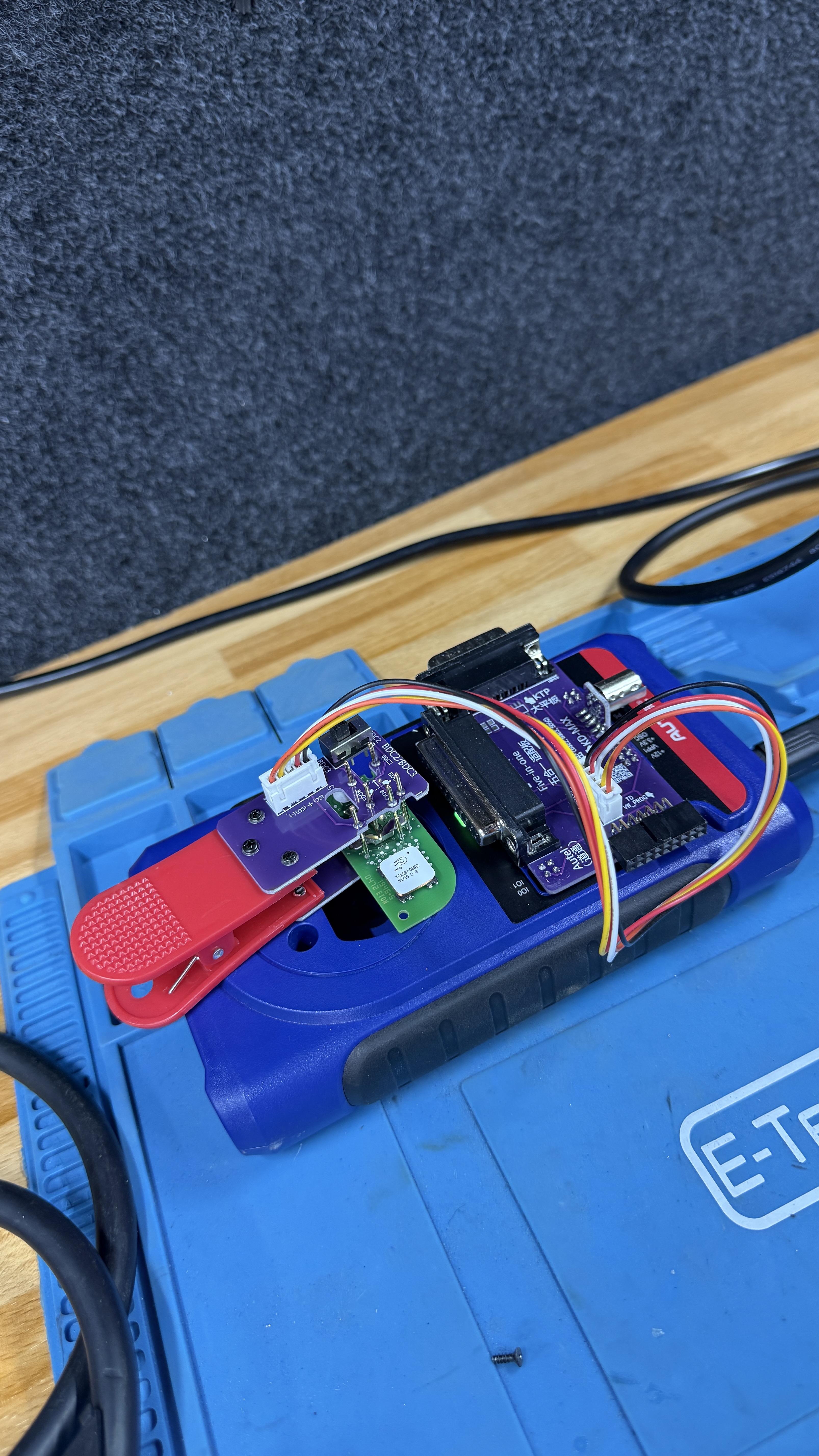 Diagnostic programming tool and circuit board on the workbench during KeyLogik key programming