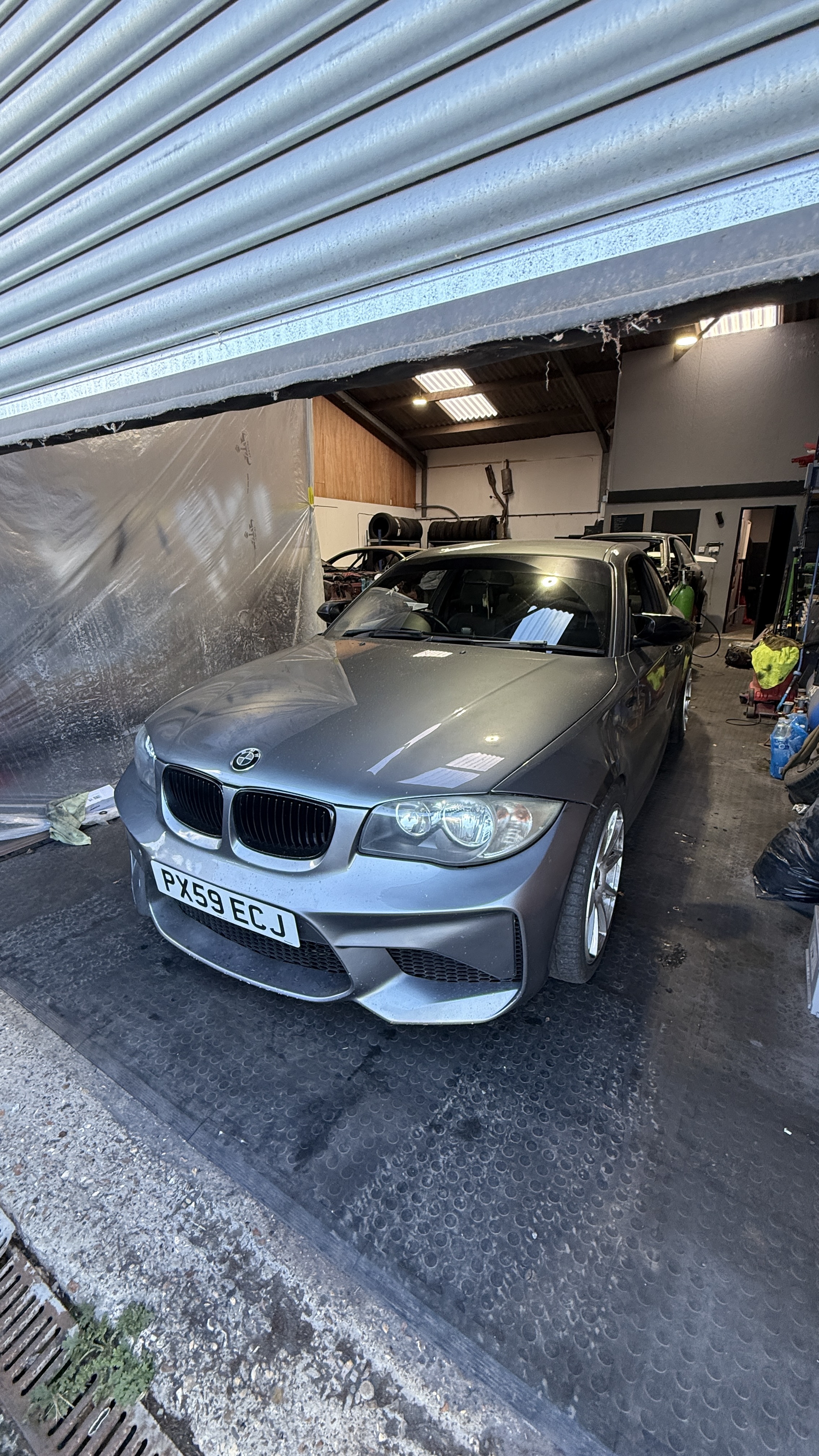 Grey BMW 1 Series attended at a workshop by KeyLogik mobile auto locksmith