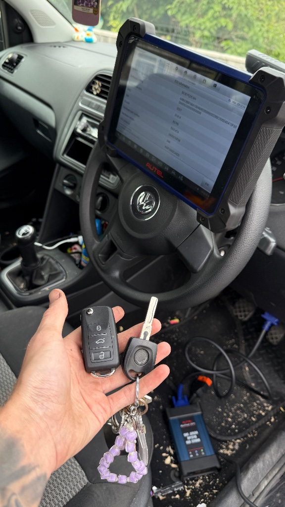 Worn original key and new replacement remote key during diagnostic programming