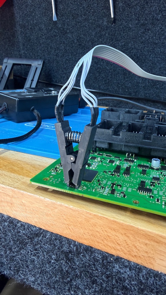 SOIC8 test clip on FEM module PCB during BMW M140i immobiliser data extraction in Abingdon