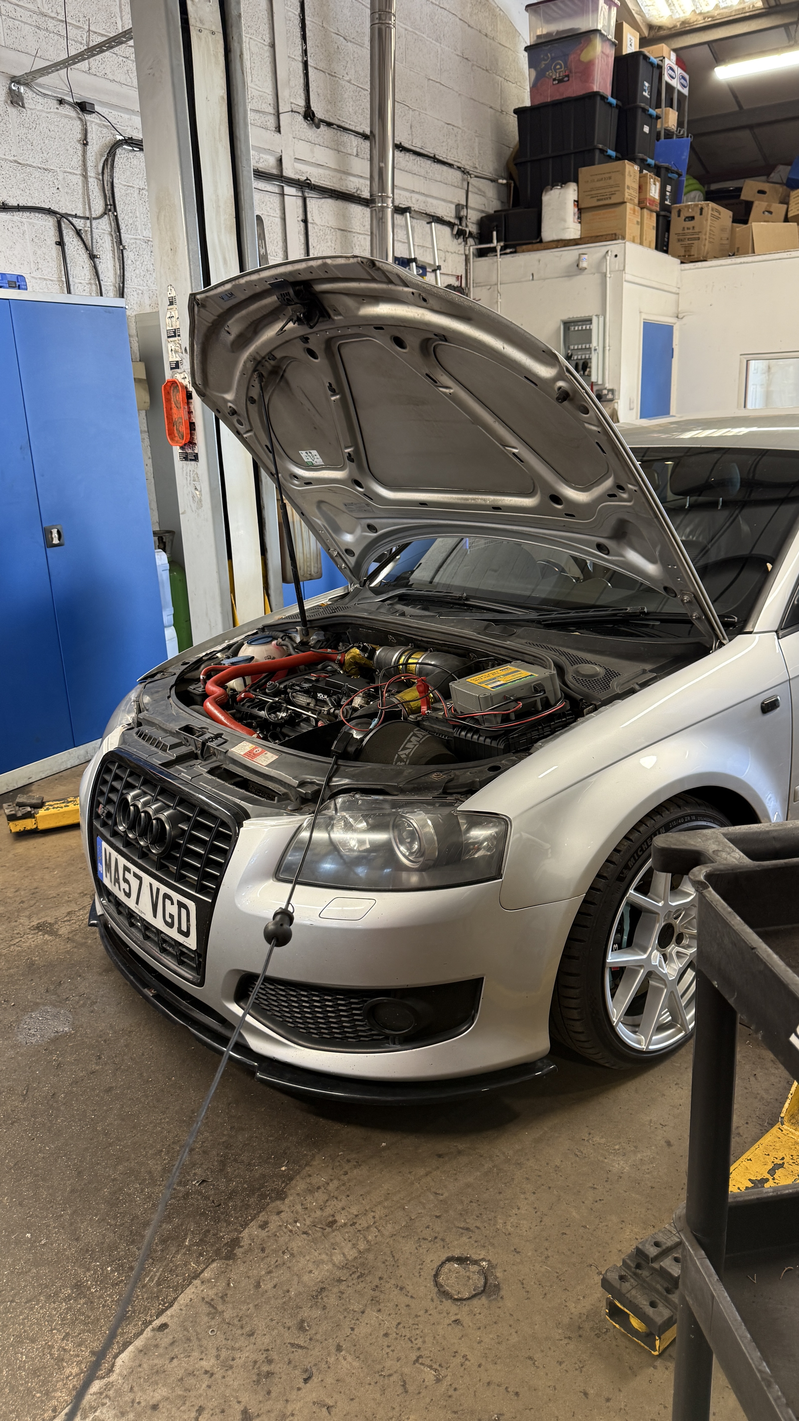 Silver Audi S3 with bonnet open and battery support connected during a Stage 2 remap in Wantage