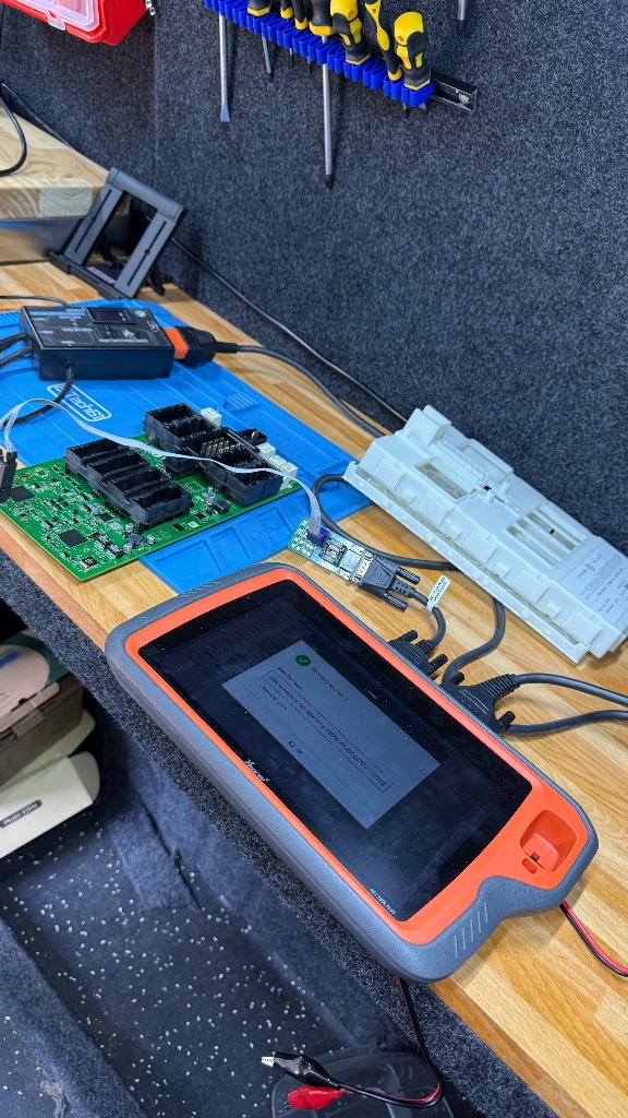 XTOOL diagnostic tablet showing programming success during BMW M140i FEM bench unlock in Abingdon