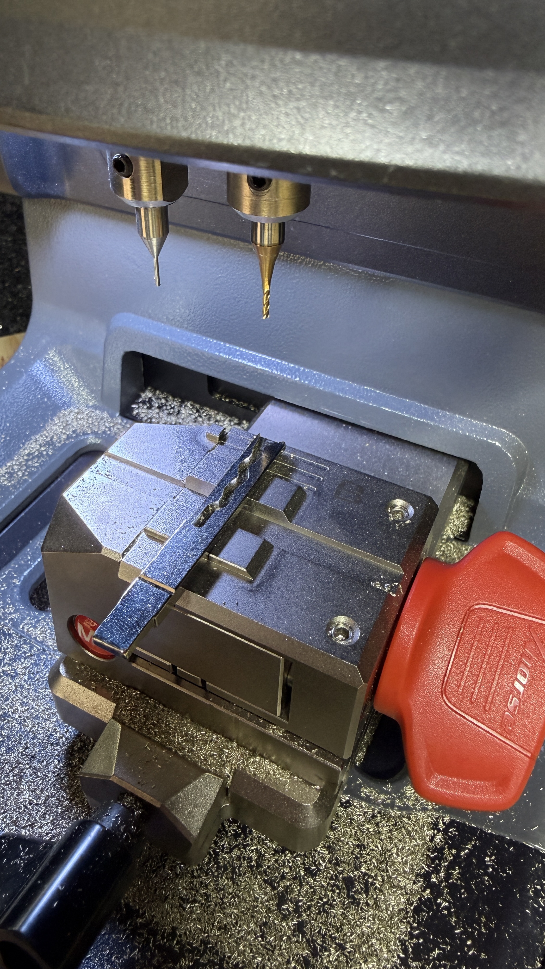 Car key blade being precision cut in an Xhorse automatic key-cutting machine by KeyLogik