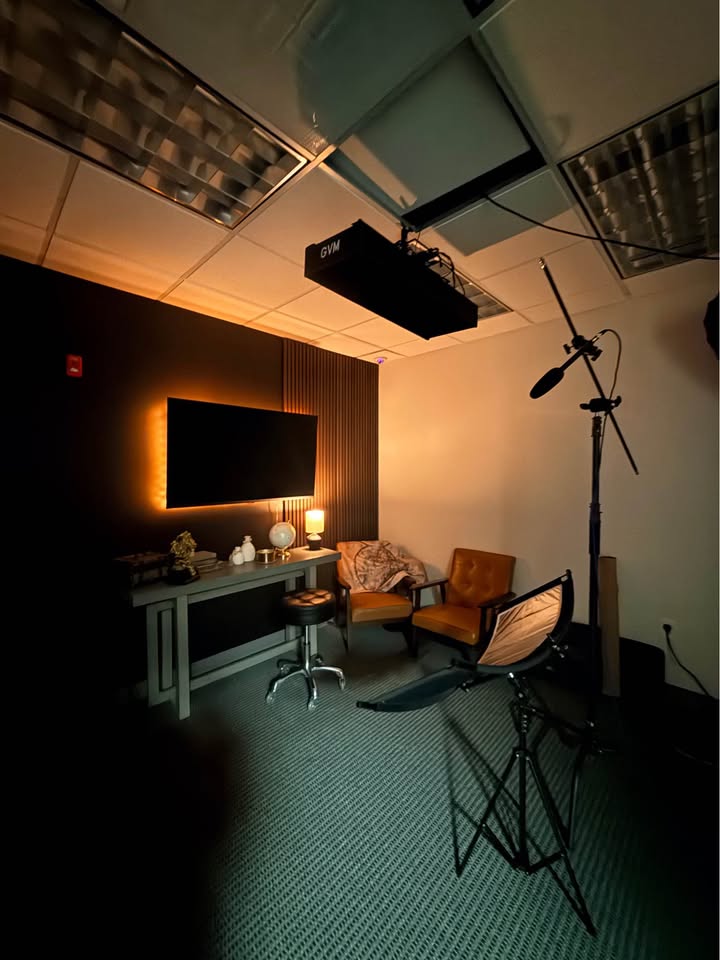 Studio set with warm lighting and microphone boom