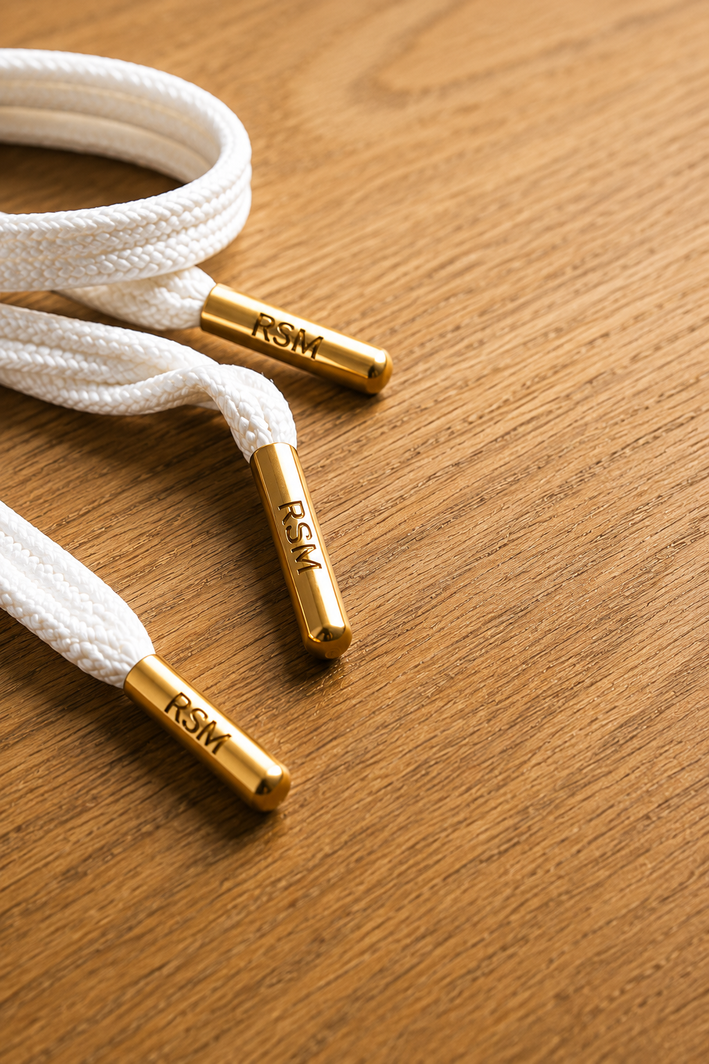 RSM Laces with gold tips on wood
