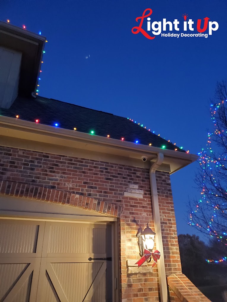 Multicolor roofline Christmas lights close-up on brick garage