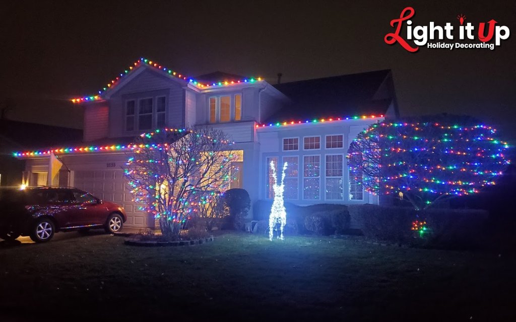 Multicolor roofline and bush Christmas lights with reindeer decoration