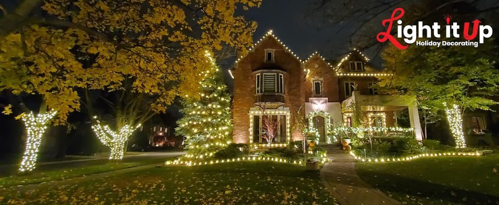 Full warm white custom display with lit trees, pathway and roofline on brick estate