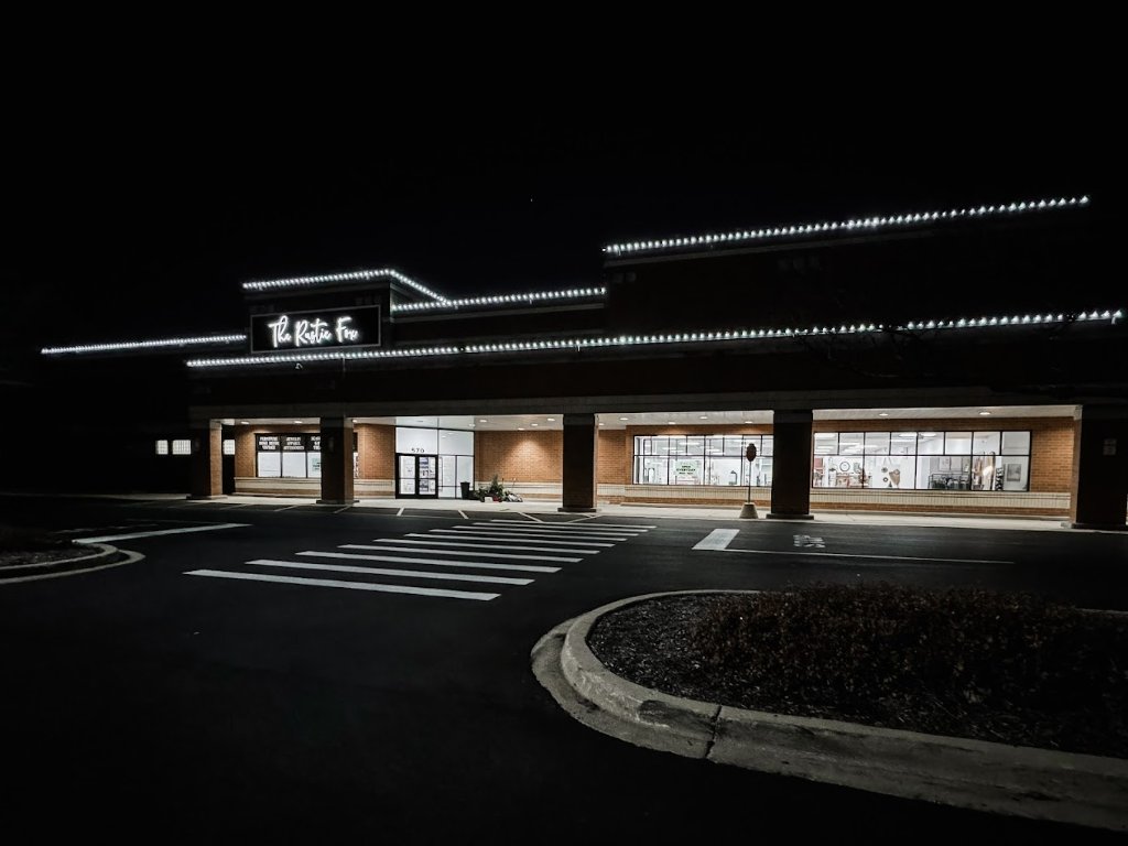 Commercial strip mall Christmas light installation with white roofline lights