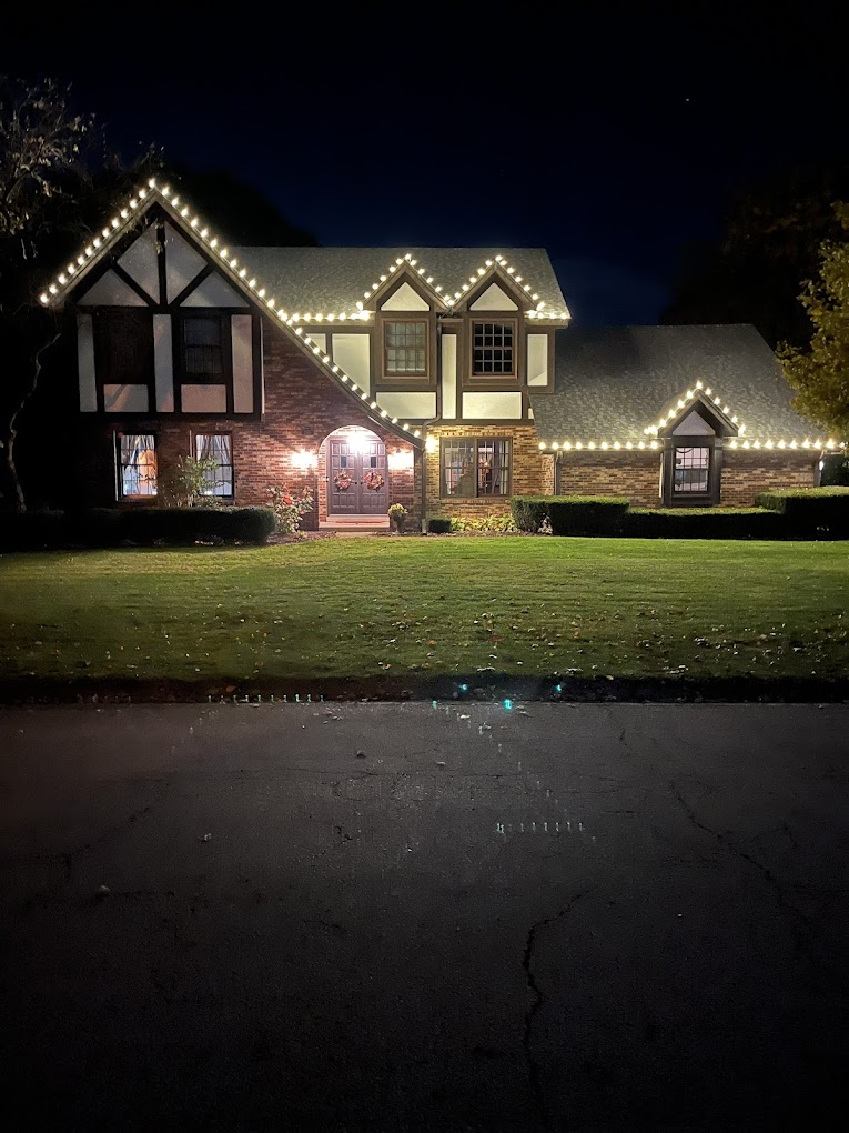 Classic warm white roofline lights on Tudor style home