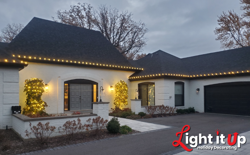 Warm white roofline and vine lights on modern white home