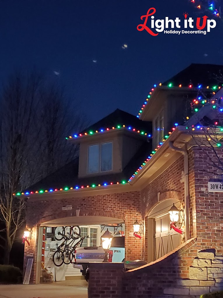 Multicolor roofline Christmas lights close-up detail on brick home