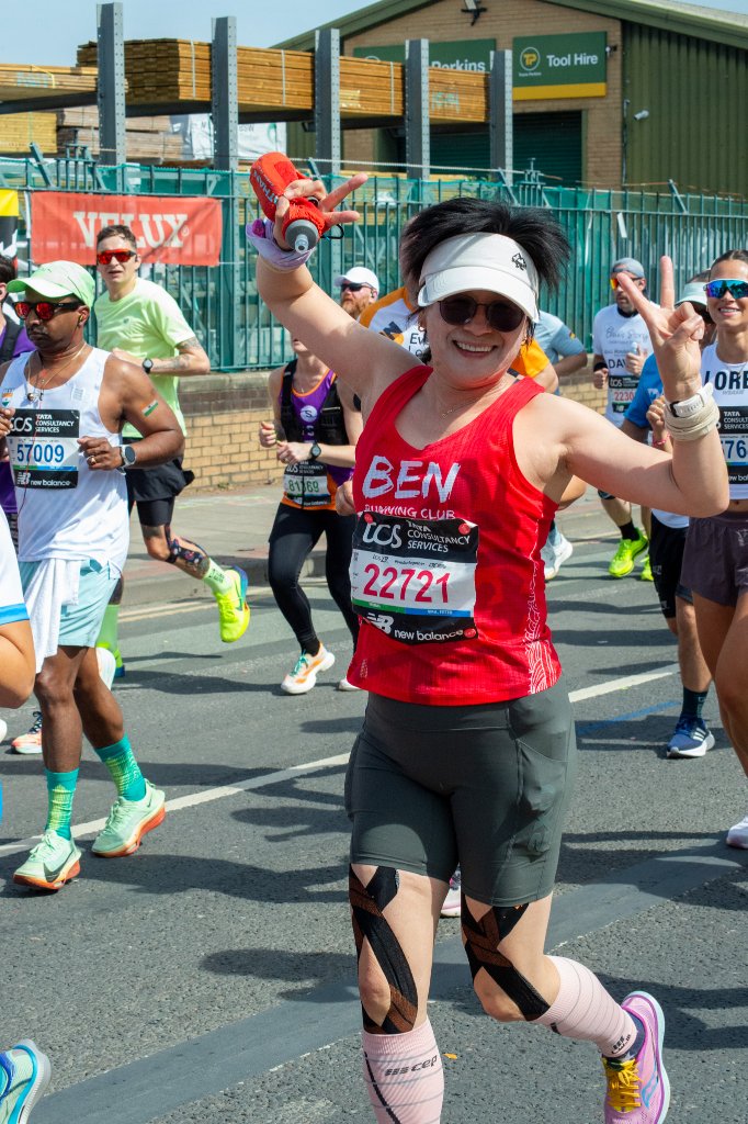 Two runners celebrating under a bridge