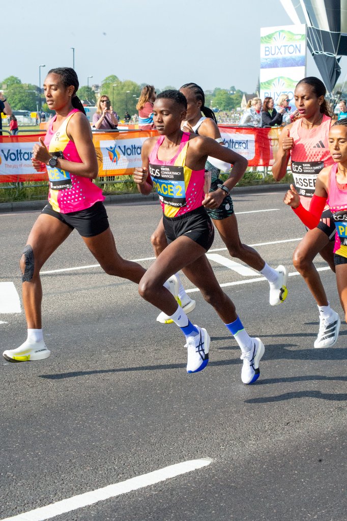 Runner in orange top high-fiving spectators