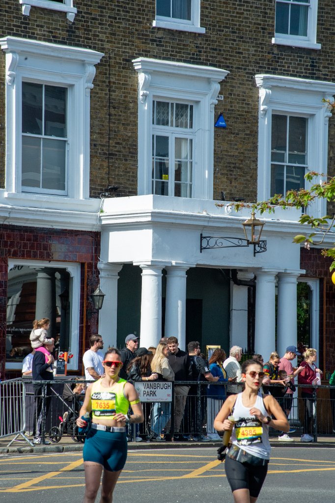 Runners pass under a bridge in south London