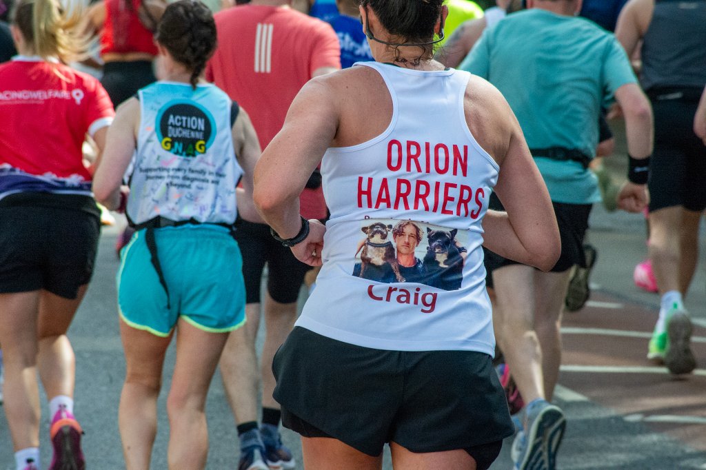 Runners with a London Marathon mural in background