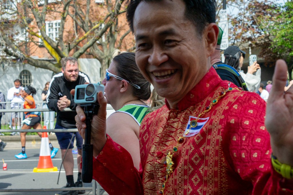 Runner in pink vest smiling at the camera