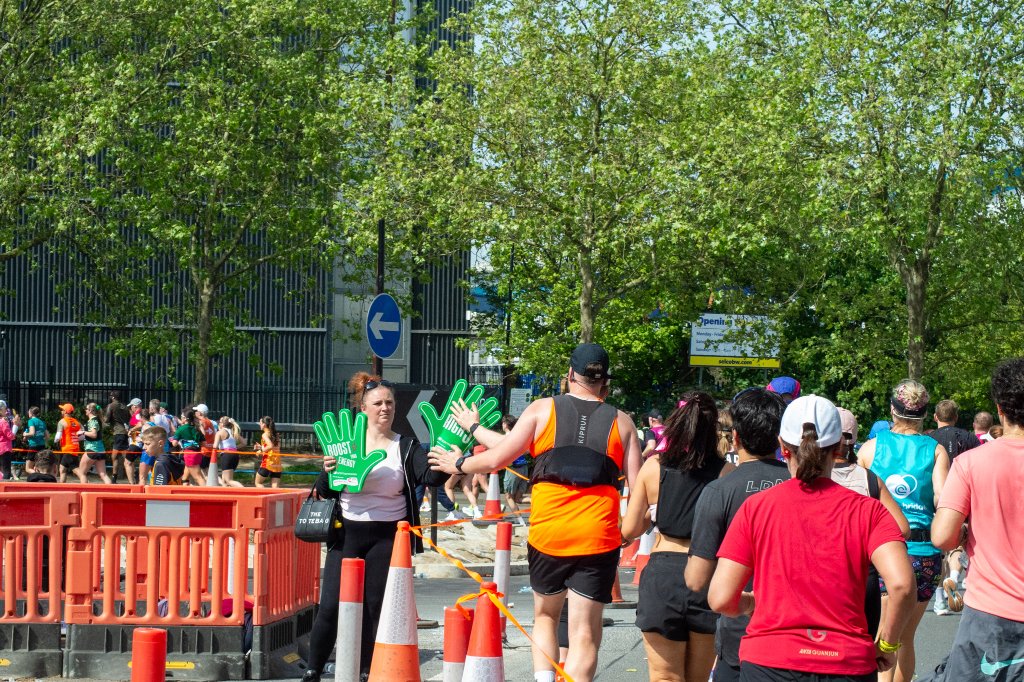 Three runners under a flyover