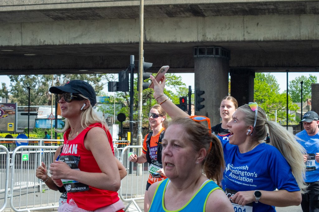 Matt runner with water bottles and supporters