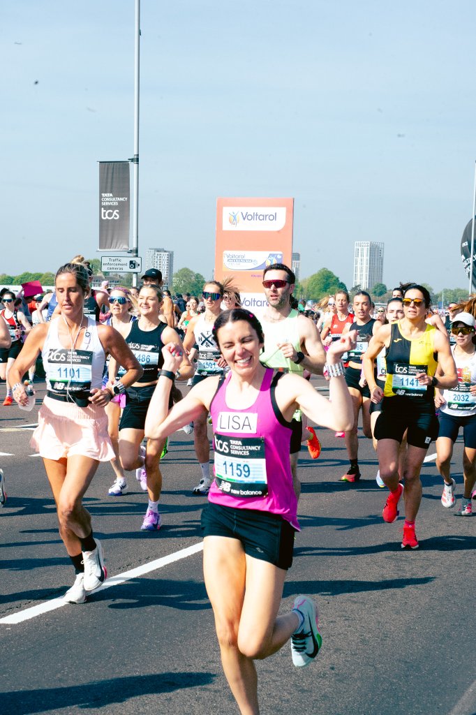 Scarlett runner smiling with rainbow sunglasses
