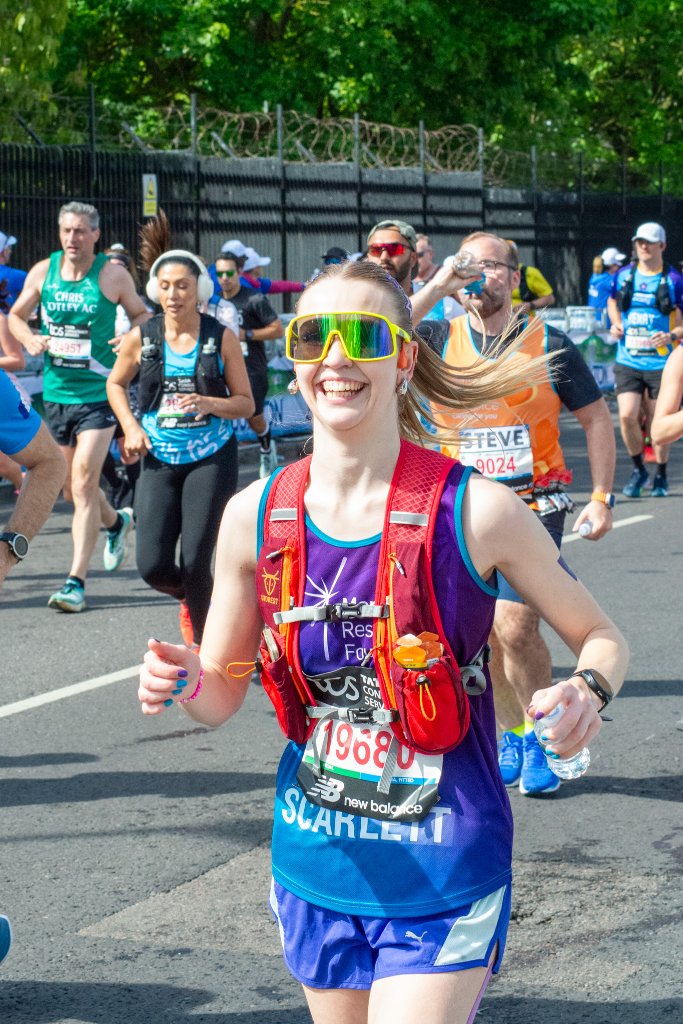 Teenager Cancer Trust runner with runners in the background