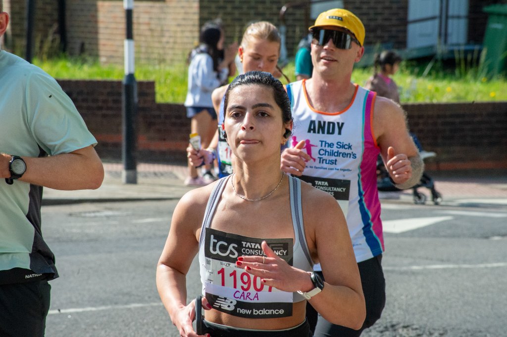 Runners past a BP petrol station with spectators