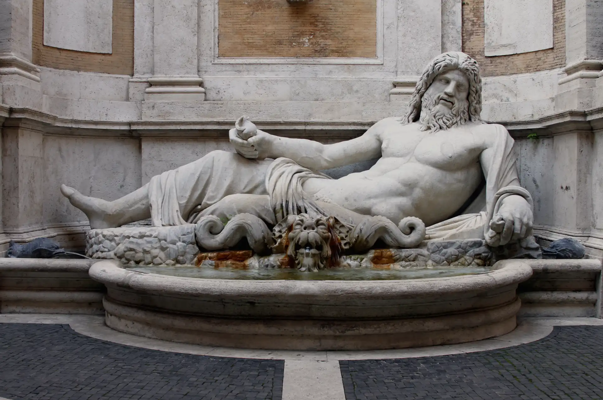 Ancient Roman marble reclining god statue for Achilles Clinic careers, soft tissue therapy jobs London