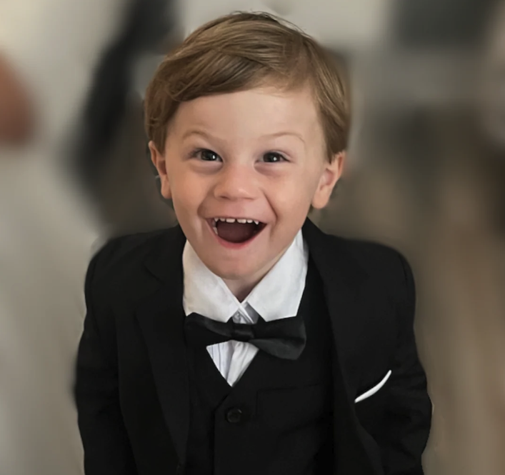 Gio smiling in a suit