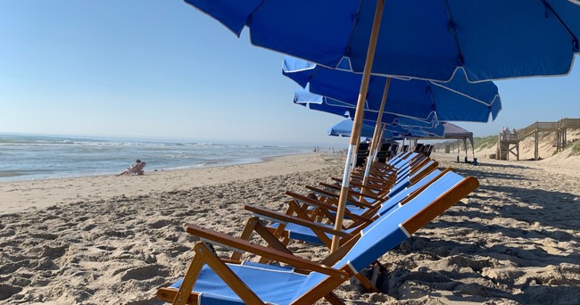 Premium Tommy Bahama beach chair and umbrella rental setup on Outer Banks NC sand by Sun Ease Rentals