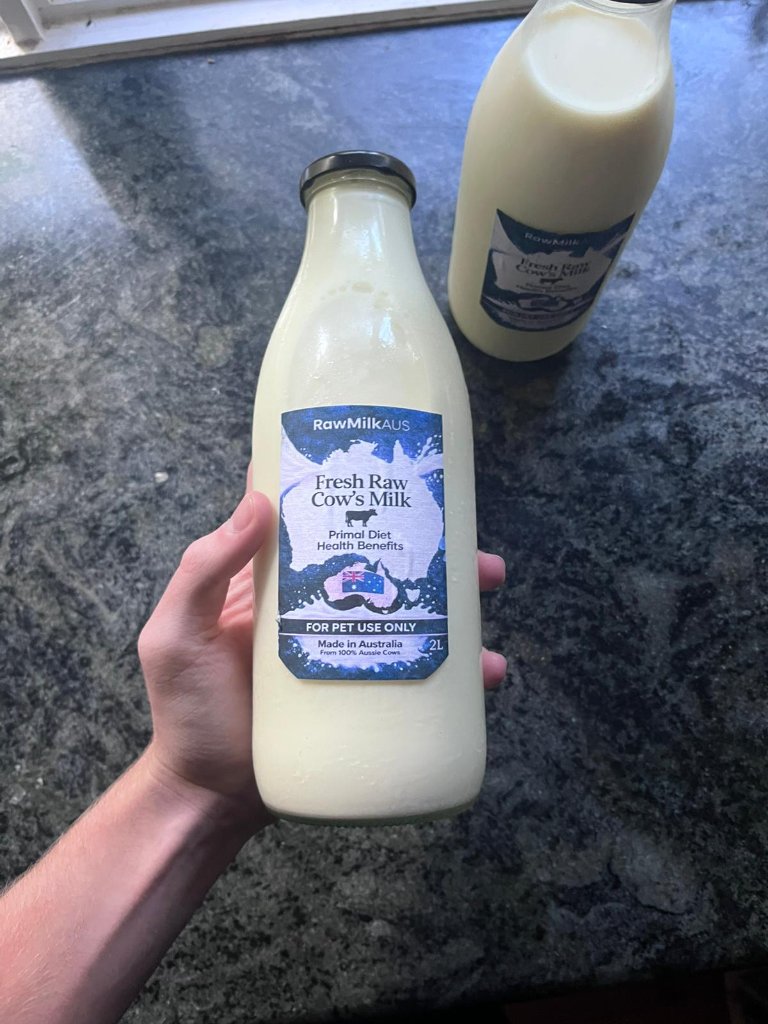 Two RawMilkAUS glass bottles side by side