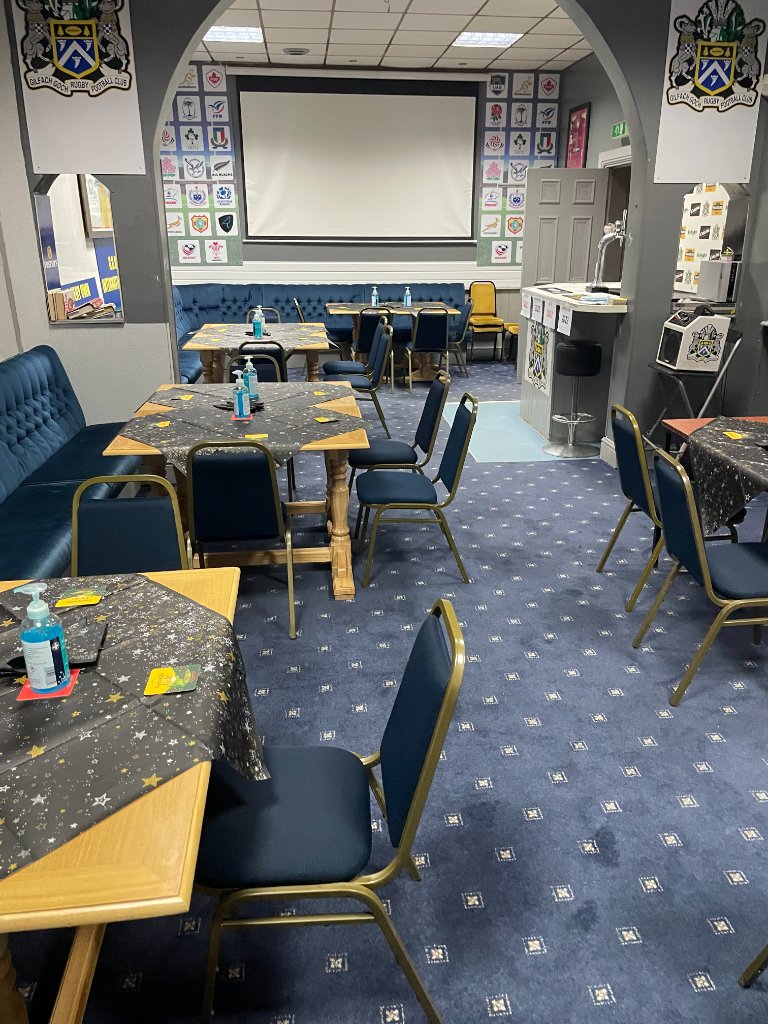 Meeting room with projection screen and club memorabilia