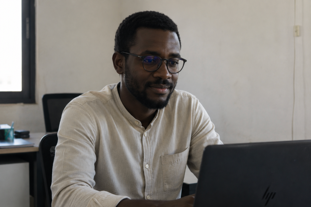 African employee focused at work, secure monthly compensation through Kernel