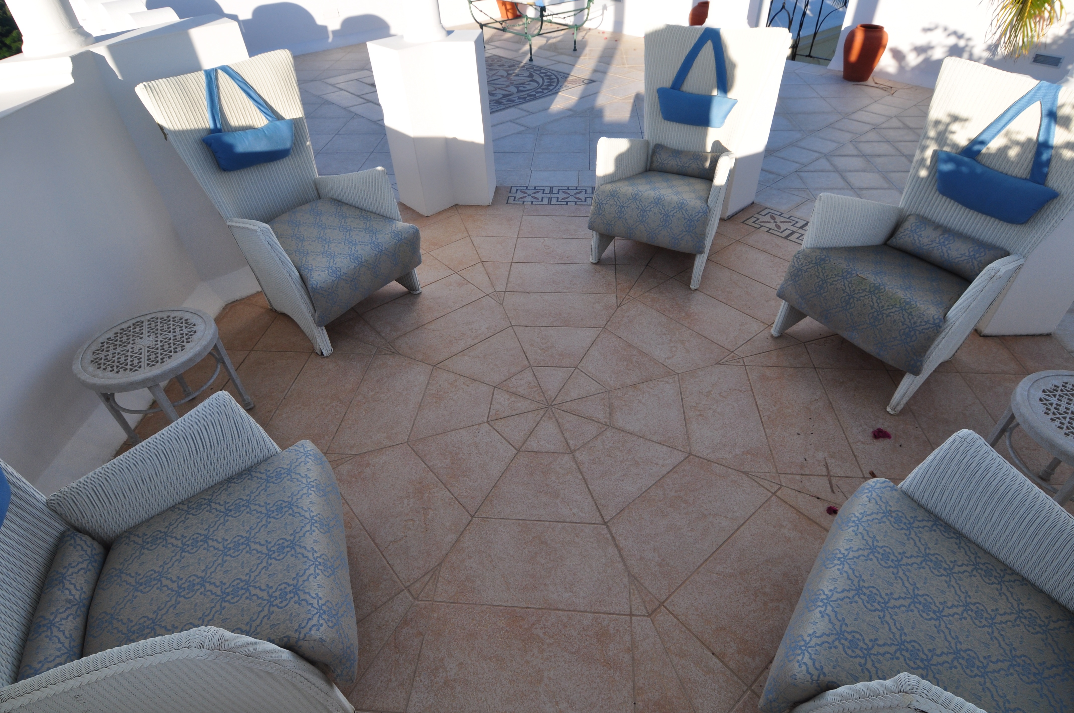 Circular patio seating arranged over radially laid stone paving on an outdoor terrace