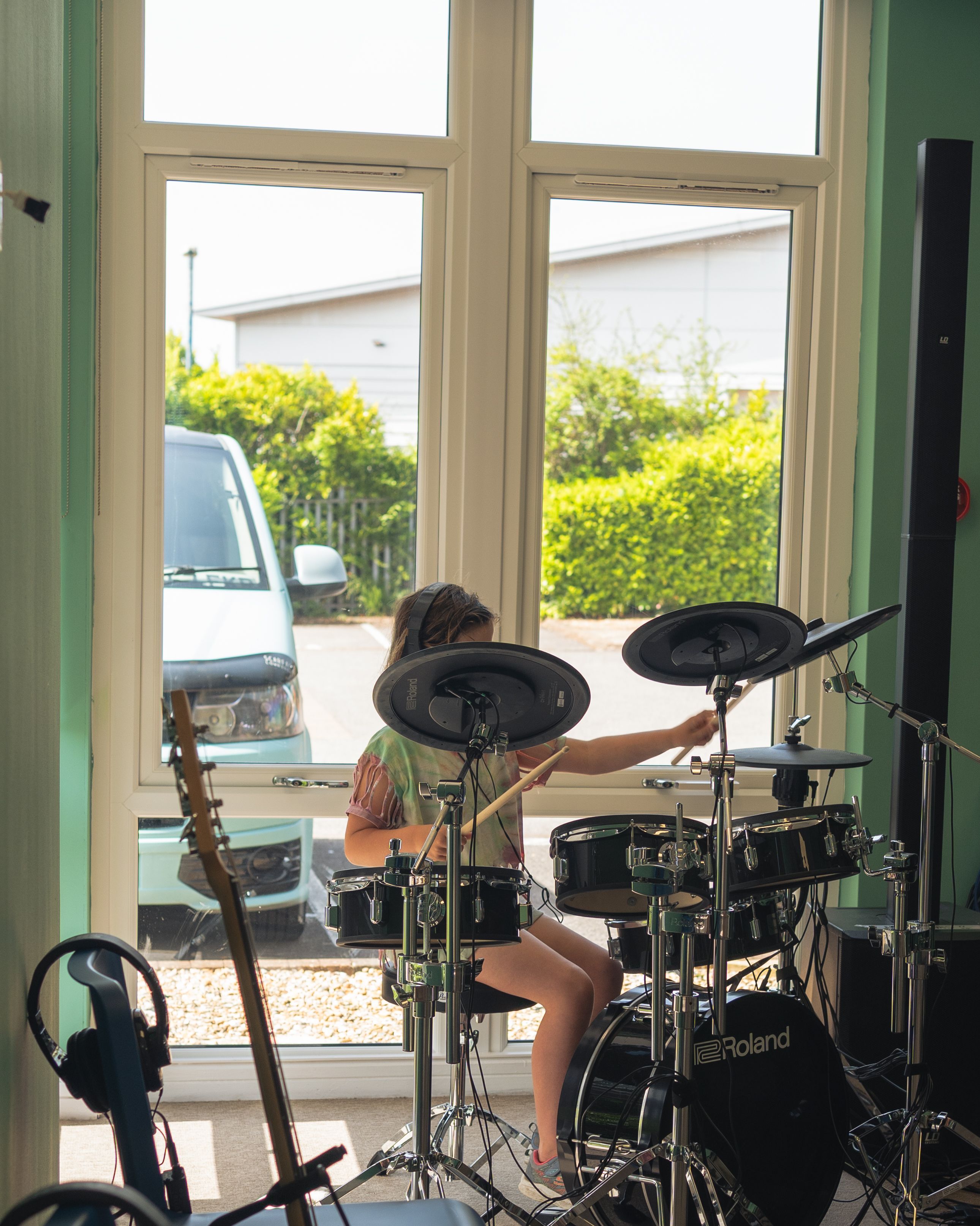 A child playing the electronic drum kit at OpenSpace