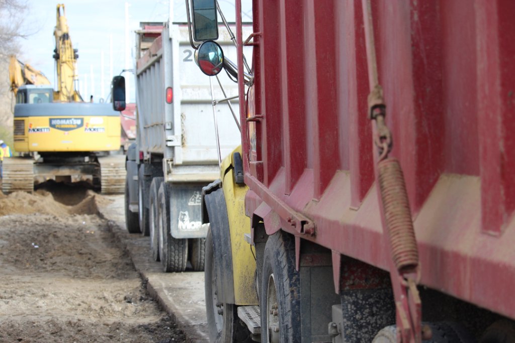 Dump trucks lined up on urban job site