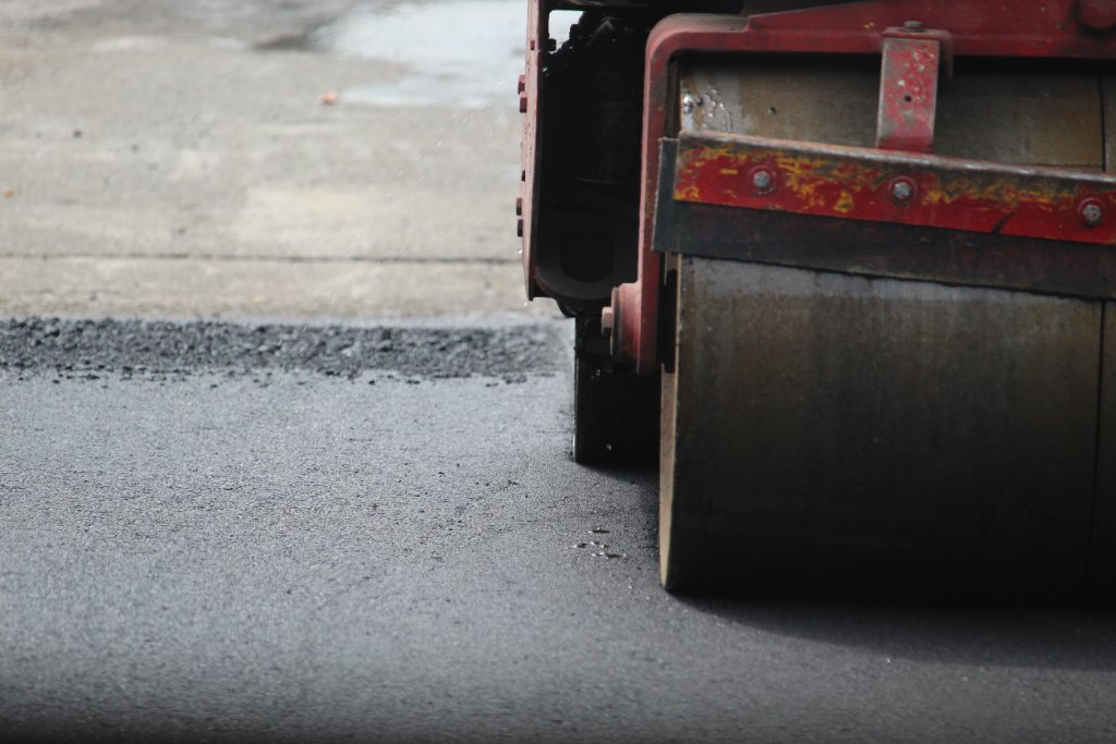 Road roller compacting asphalt