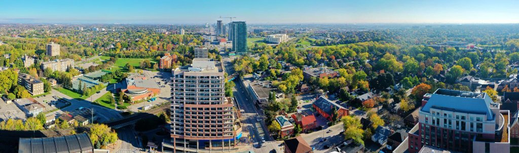 Aerial daytime view of Brampton with green spaces and downtown buildings