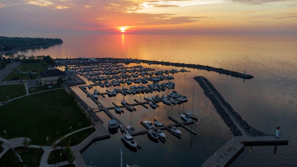 Oakville Harbour at sunset with sailboats and lighthouse