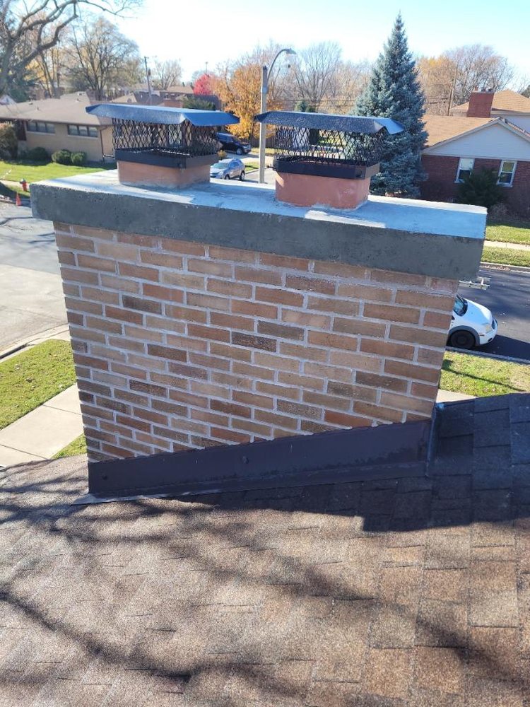 Rebuilt brick chimney with new chimney caps
