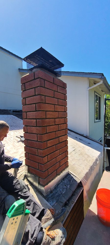Tall rebuilt brick chimney after restoration