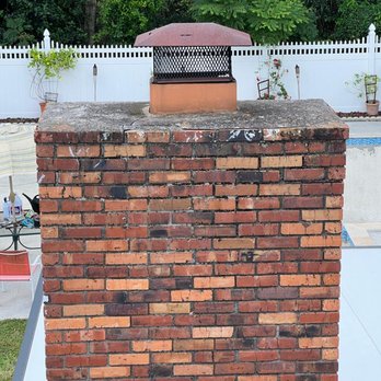Brick chimney with new chimney cap installed