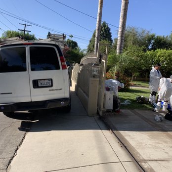 Cleaning crew preparing equipment outside home
